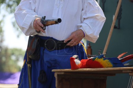 Photo for 4-15-2023: Visalia, California: People in period costumes doing a parrot show at a Renaissance Faire - Royalty Free Image