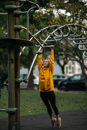 Photo for A woman doing exercises in the city park. - Royalty Free Image