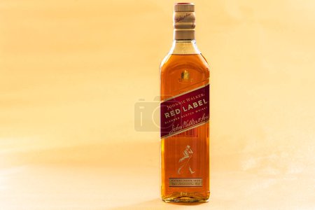 Photo for Edinburgh, UK - May 30, 2023:  Johnnie Walker Red Label Blended Scotch Whisky on yellow background - Royalty Free Image