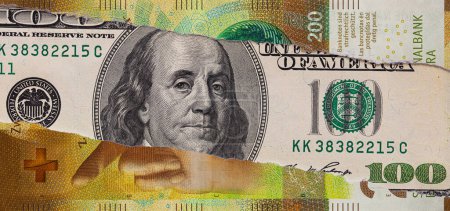 100 US dollar banknote through torn 200 Swiss franc banknote for design purpose