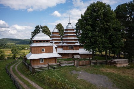 Photo for Matkiv, Ukraine - July 21, 2021: Aerial view on ancient wooden Church of Synaxis of the Holy Mother of God in Matkiv, Lviv region, Ukraine from drone - Royalty Free Image