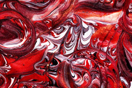 Closeup of red fluid metallic paint textured background for design purpose
