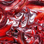 Closeup of red fluid metallic paint textured background for design purpose