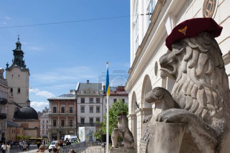 Photo for Lion monument in Ukrainian military beret near Lviv city hall, Ukraine - Royalty Free Image