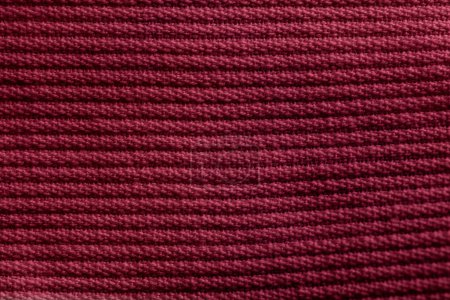 Closeup of pink corduroy cloth as patterned textured background for design purpose