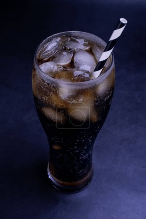 Photo for Cool glass of cola drink with ice, bubbles and fizz. Fresh cold sweet with ice cubes. Cola glass with summer refreshment on black. - Royalty Free Image