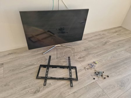 Photo for Digital LED tv fixing on the wall process. Preparation for mounting bracket - Royalty Free Image