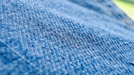 Téléchargez les photos : Close-up shot of denim jeans fabric texture in vibrant blue. - en image libre de droit