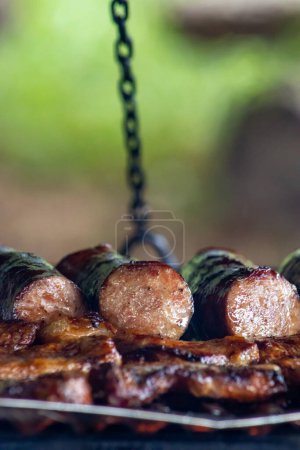 Photo for "Sizzling sausage on a campfire ultimate camping food delight" - Royalty Free Image