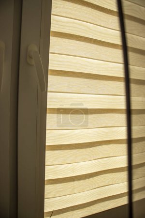 Photo for Bright day and night view from a window covered with brown shade - Royalty Free Image
