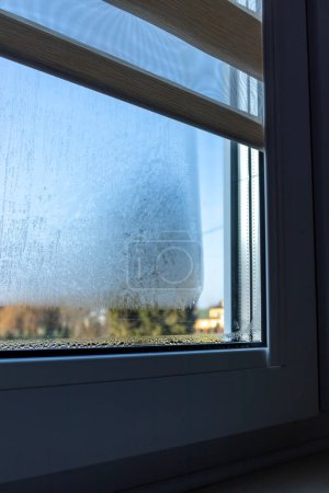 Indoor close-up of a leaky window. Condensate water on window