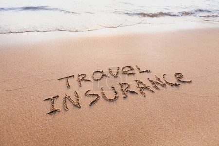 Photo for Travel insurance concept, text words written on the sand - Royalty Free Image