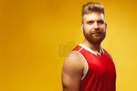 Photo for Fabulous at any age. Emotive portrait of smiling charismatic muscular 30-year-old man standing over yellow background. Perfect body and haircut. Sport style. Copy-space. Studio shot - Royalty Free Image