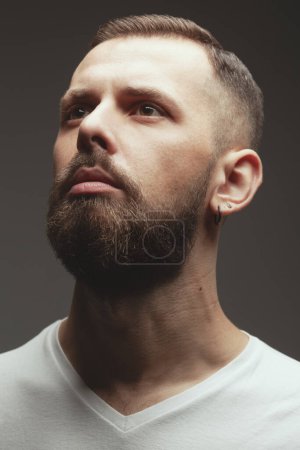 Photo for Male beauty concept. Portrait of praying charismatic active 30-year-old man posing over gray background. Perfect haircut. Hipster style. Close up. Studio shot - Royalty Free Image