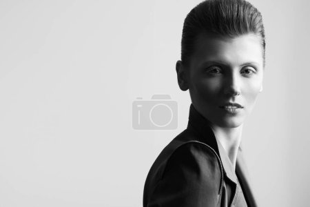 Photo for Art fashion concept. Portrait of androgynous model with short hair in casual jacket posing over gray background. Pale skin, serious face, natural make-up. Close up. Copy-space. Studio shot - Royalty Free Image