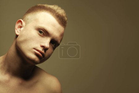Photo for Male beauty concept. Portrait of fashionable young man with stylish haircut posing over mustard background. Perfect hair, skin. Tough guy. Hipster style. Close up. Copy-space. Studio shot - Royalty Free Image