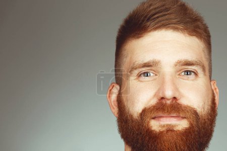 Photo for Fabulous at any age. Close up portrait of charismatic muscular 30-year-old man with red hair posing over light gray background. Perfect haircut. Studio shot - Royalty Free Image