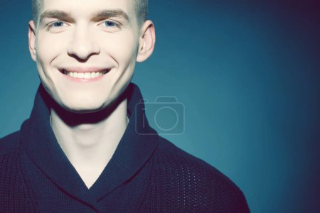 Photo for Male beauty concept. Portrait of a young smilimg handsome man in trendy sweater looking at camera and smiling. Healthy skin and teeth. Hipster style. Close up. Copy-space. Studio shot - Royalty Free Image