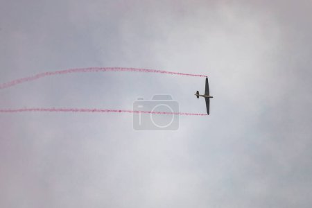 Photo for Leszno, Poland - June 16 2023: Antidotum Airshow Leszno 2023 and acrobatic shows of DFS Habicht sky glider with smoke show at cloudy sky - Royalty Free Image