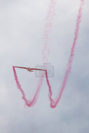 Photo for Leszno, Poland - June 16 2023: Antidotum Airshow Leszno 2023 and acrobatic shows of DFS Habicht sky glider with smoke show at cloudy sky - Royalty Free Image