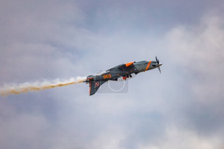Photo for Leszno, Poland - June 16 2023: Antidotum Airshow Leszno 2023 and acrobatic shows of PZL-130 Orlik training plane on blue cloudy sky - Royalty Free Image