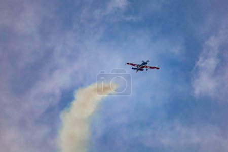 Photo for Leszno, Poland - June 16 2023: Antidotum Airshow Leszno 2023 and acrobatic shows full of smoke of Equipe de Voltige on blue cloudy sky - Royalty Free Image