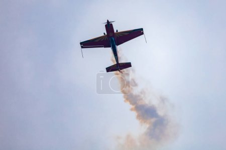 Photo for Leszno, Poland - June 16 2023: Antidotum Airshow Leszno 2023 and acrobatic shows full of smoke of The Royal Jordanian Falcons team on a cloudy sky - Royalty Free Image