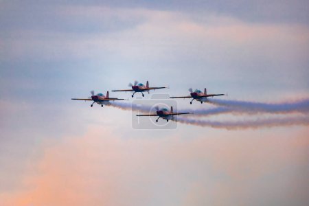 Photo for Leszno, Poland - June 16 2023: Antidotum Airshow Leszno 2023 and acrobatic shows full of smoke of The Royal Jordanian Falcons team on a cloudy sky - Royalty Free Image