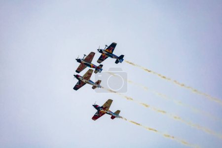 Photo for Leszno, Poland - June 16 2023: Antidotum Airshow Leszno 2023 and acrobatic shows full of smoke of The Fyling Bulls Acrobatic Team on a cloudy sky - Royalty Free Image