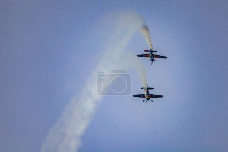 Photo for Leszno, Poland - June 16 2023: Antidotum Airshow Leszno 2023 and acrobatic shows full of smoke of The Fyling Bulls Acrobatic Team on a cloudy sky - Royalty Free Image