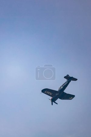 Photo for Leszno, Poland - June 16 2023: Antidotum Airshow Leszno 2023 and acrobatic shows full of smoke of Red Bull F4U Corsair on a cloudy sky - Royalty Free Image
