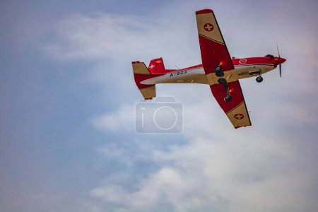 Photo for Leszno, Poland - June 16 2023: Antidotum Airshow Leszno 2023 and acrobatic shows full of smoke of PC-7 planes team on a cloudy sky - Royalty Free Image