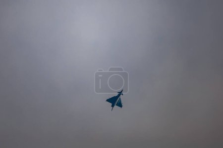 Photo for Leszno, Poland - June 16 2023: Antidotum Airshow Leszno 2023 and acrobatic shows full of smoke of Eurofighter Typhoon plane on a cloudy sky - Royalty Free Image