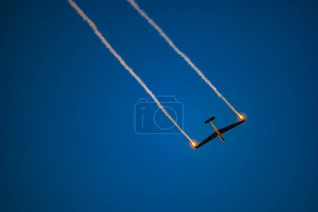 Photo for Leszno, Poland - June 16 2023: Antidotum Airshow Leszno 2023 and acrobatic shows full of smoke of Johan Gustafsson airshows on a cloudy sky - Royalty Free Image