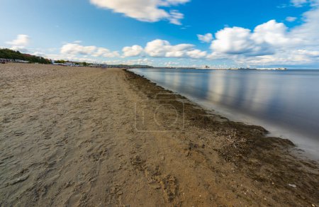 Photo for Sopot, Poland - July 22 2023: Beautiful shoreline of big sandy beach and Baltic sea at cloudy and windy day catched at long exposure - Royalty Free Image