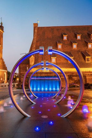 Photo for Gdansk, Poland - September 7 2023: Beautiful Hevelius fountain highlighted by colorful lights around and splashing water around at dark afternoon - Royalty Free Image