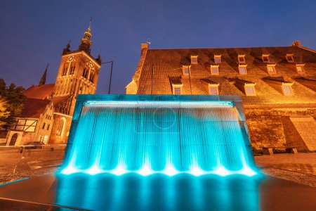 Photo for Gdansk, Poland - September 7 2023: Beautiful Hevelius fountain highlighted by colorful lights around and splashing water around at dark afternoon - Royalty Free Image