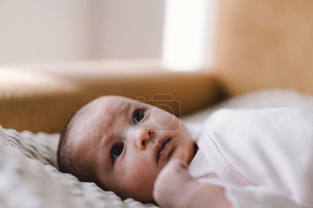 Photo for Portrait of a 1 month old baby. Cute newborn baby lying on a developing rug. Love baby. Newborn baby and mother. - Royalty Free Image