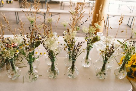 Elegant Wildflower Centerpieces Adorning a Festive Table at an Indoor Event of a long table