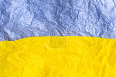 Papier in den blauen und gelben Farben der Flagge der Ukraine, UA. Blaue und gelbe Farben. Nahaufnahme, Hintergrund