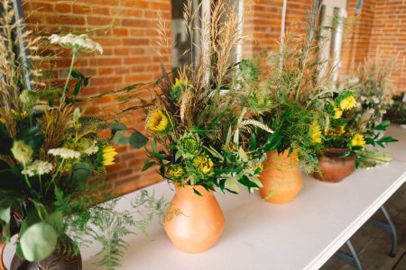 Elegant Wildflower Centerpieces Adorning a Festive Table at an Indoor Event of a long table