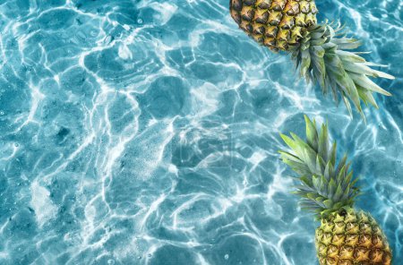 Photo for Yellow pineapple on a blue water background. Exotic concept. - Royalty Free Image