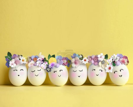 Foto de Colección de elegantes colores huevos con flores para la celebración de Pascua sobre fondo amarillo. Concepto de vacaciones. - Imagen libre de derechos