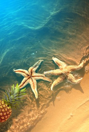 Foto de Yellow pineapple and starfish on a blue water background. Exotic concept. - Imagen libre de derechos