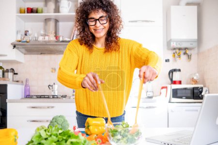 Photo for Happy black woman preparing healthy food vegetables salad at home - Royalty Free Image