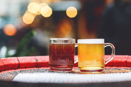 Photo for Two glasses mugs with red and white mulled wine on Christmas Market in Germany. Traditional alcoholic drinks on German xmas funfair. - Royalty Free Image