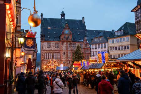 Photo for MARBURG, GERMANY - 4 December, 2022: : Old market place with the christmas decoration, old houses with stores, restaurants and visitors of the christmas market. Traditional Christmas market. - Royalty Free Image