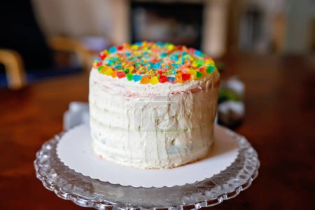 Photo for Closeup of homemade rainbow cake with 6 candles - Royalty Free Image