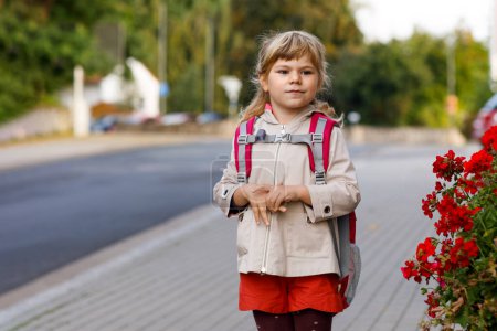 Photo for Cute little preschool girl going to playschool. Healthy toddler child walking to nursery school and kindergarten. Happy child with backpack on the city street, outdoors - Royalty Free Image