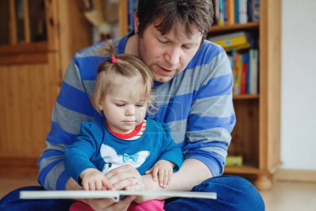 Photo for Portrait of caucasian father hold story book reading with daughter little girl. Home school learn from teacher, education happy family love together, bed time story fathers day concept. - Royalty Free Image